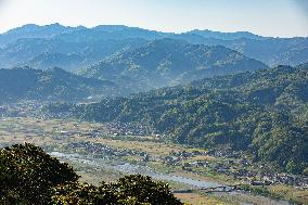 Images of farmhouses, mountain ranges, rice paddies, fields, and rivers