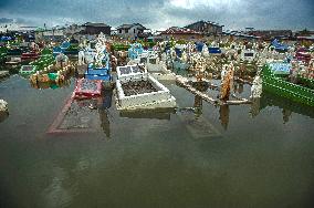 Public Grave Submerged By Tidal Flood - Indonesia