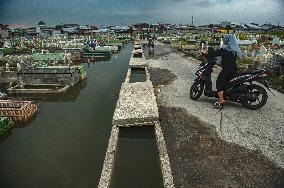 Public Grave Submerged By Tidal Flood - Indonesia