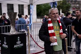 Olympiacos Fans Are Photographed With The Conference Cup Trophy