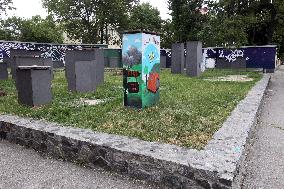 Kevlar protective structures shielding stone women from shelling painted in Dnipro