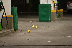 Evidence Markers At Scene Of 35-Year-Old Male Inside Pickup Truck In Gas Station Parking Lot Shot And Killed