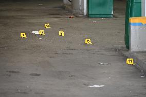 Evidence Markers At Scene Of 35-Year-Old Male Inside Pickup Truck In Gas Station Parking Lot Shot And Killed