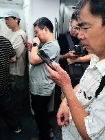 Passengers Play With Phones in Beijing Subway