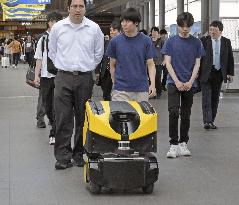 Tram-riding delivery robot