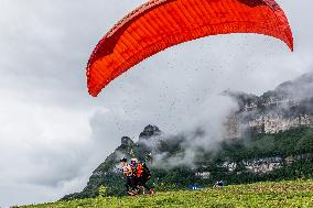 Tourists Ride Paragliders Over The World Natural Heritage site of Jinfo Mountain in Chongqing