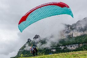 Tourists Ride Paragliders Over The World Natural Heritage site of Jinfo Mountain in Chongqing