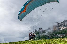 Tourists Ride Paragliders Over The World Natural Heritage site of Jinfo Mountain in Chongqing