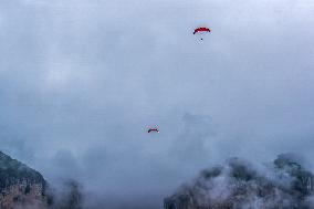 Tourists Ride Paragliders Over The World Natural Heritage site of Jinfo Mountain in Chongqing