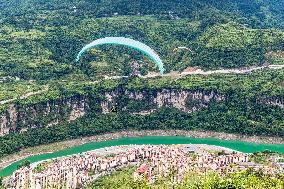 Tourists Ride Paragliders Over The World Natural Heritage site of Jinfo Mountain in Chongqing