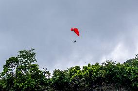 Tourists Ride Paragliders Over The World Natural Heritage site of Jinfo Mountain in Chongqing