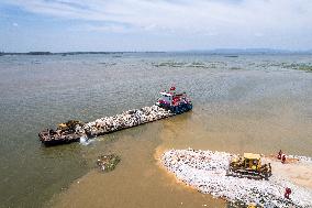 Work Begins Sealing Breach At Freshwater Lake - China