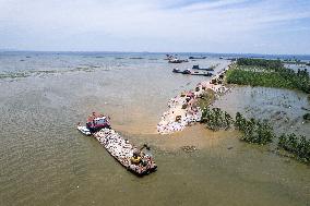 Work Begins Sealing Breach At Freshwater Lake - China