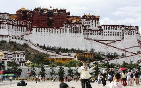 Tourists Visit The Potala Palace in Lhasa