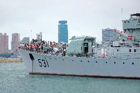 Tourists Visit A Decommissioned Warship in Qingdao