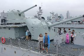 Tourists Visit A Decommissioned Warship in Qingdao