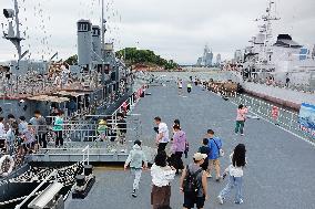 Tourists Visit A Decommissioned Warship in Qingdao