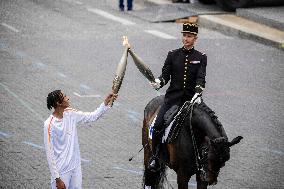 Olympic flame during the annual Bastille Day military parade - Paris