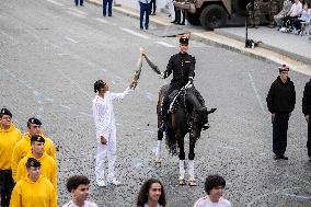 Olympic flame during the annual Bastille Day military parade - Paris