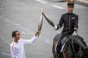 Olympic flame during the annual Bastille Day military parade - Paris