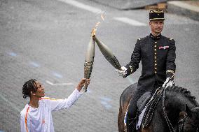 Olympic flame during the annual Bastille Day military parade - Paris