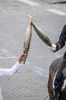 Olympic flame during the annual Bastille Day military parade - Paris