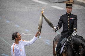 Olympic flame during the annual Bastille Day military parade - Paris