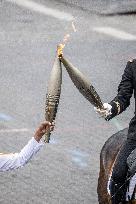 Olympic flame during the annual Bastille Day military parade - Paris