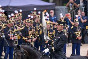 Olympic flame during the annual Bastille Day military parade - Paris