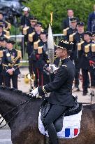 Olympic flame during the annual Bastille Day military parade - Paris