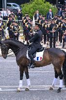 Olympic flame during the annual Bastille Day military parade - Paris