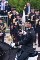 Olympic flame during the annual Bastille Day military parade - Paris