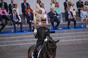 Olympic flame during the annual Bastille Day military parade - Paris