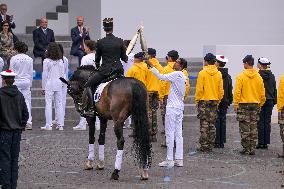 Olympic flame during the annual Bastille Day military parade - Paris