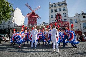 Paris 2024 - The Olympic Flame Stops By The Moulin Rouge