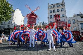 Paris 2024 - The Olympic Flame Stops By The Moulin Rouge