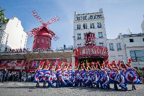 Paris 2024 - The Olympic Flame Stops By The Moulin Rouge