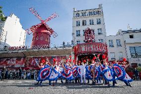 Paris 2024 - The Olympic Flame Stops By The Moulin Rouge