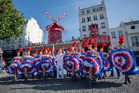 Paris 2024 - The Olympic Flame Stops By The Moulin Rouge