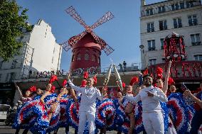 Paris 2024 - The Olympic Flame Stops By The Moulin Rouge