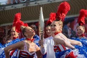 Paris 2024 - The Olympic Flame Stops By The Moulin Rouge