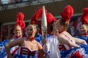 Paris 2024 - The Olympic Flame Stops By The Moulin Rouge