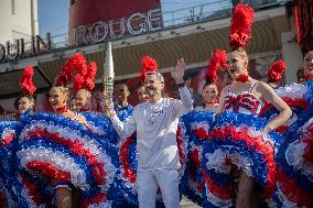 Paris 2024 - The Olympic Flame Stops By The Moulin Rouge