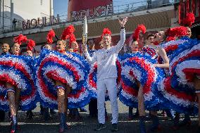 Paris 2024 - The Olympic Flame Stops By The Moulin Rouge