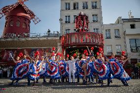 Paris 2024 - The Olympic Flame Stops By The Moulin Rouge