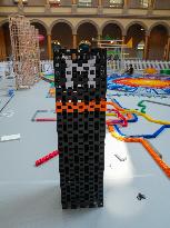 Domino Artist Lily Hevesh Prepares 100,000 Dominos In The National Building Museum For A Topple.