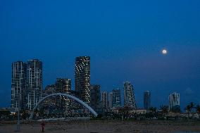 A Buck Full Moon Appears Over Colombo.