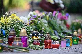 Lviv residents bring flowers to murder site of Iryna Farion