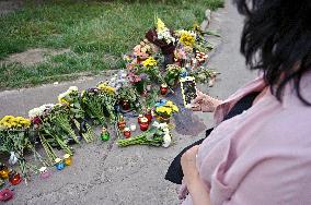 Lviv residents bring flowers to murder site of Iryna Farion