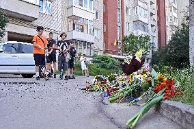 Lviv residents bring flowers to murder site of Iryna Farion